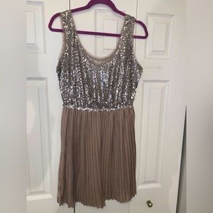Champagne colored mini dress with sliky looking bottom and sparkly top